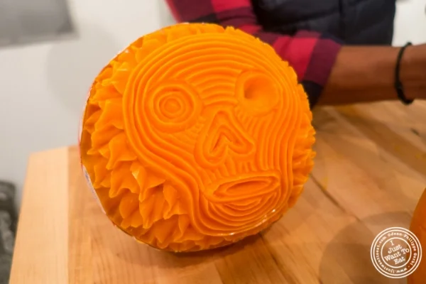 Artist Krai carving mimolette for Halloween at The French Cheese Board