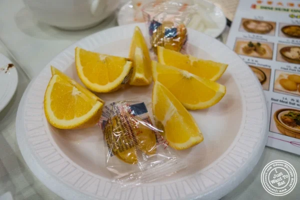 Fortune cookies and orange at Jing Fong, Dim Sum Restaurant in Chinatown, New York, NY