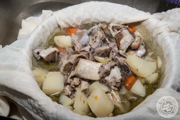 Draining the broth in a cheese cloth
