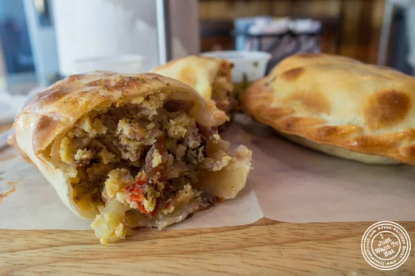 Eggs, bacon, cheese, peppers and onions empanada at Empanadas Café in Hoboken, NJ