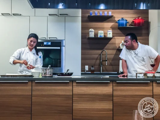 Diana Kang making donuts watched by Chef Hooni Kim at De Gustibus Cooking School at Macy's, NYC, NY