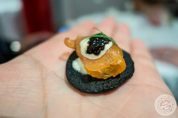 Squid ink blini with smoked salmon from Marcia Selden Catering