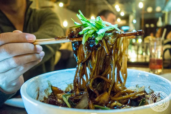 Thick noodles in black bean sauce with pork belly at Hanjan in NYC, New York