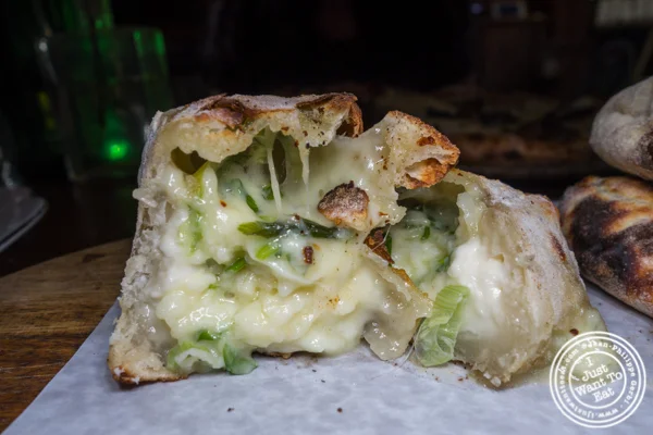 Onion and cheese empanada at Shelter Pizza in Williamsburg, Brooklyn