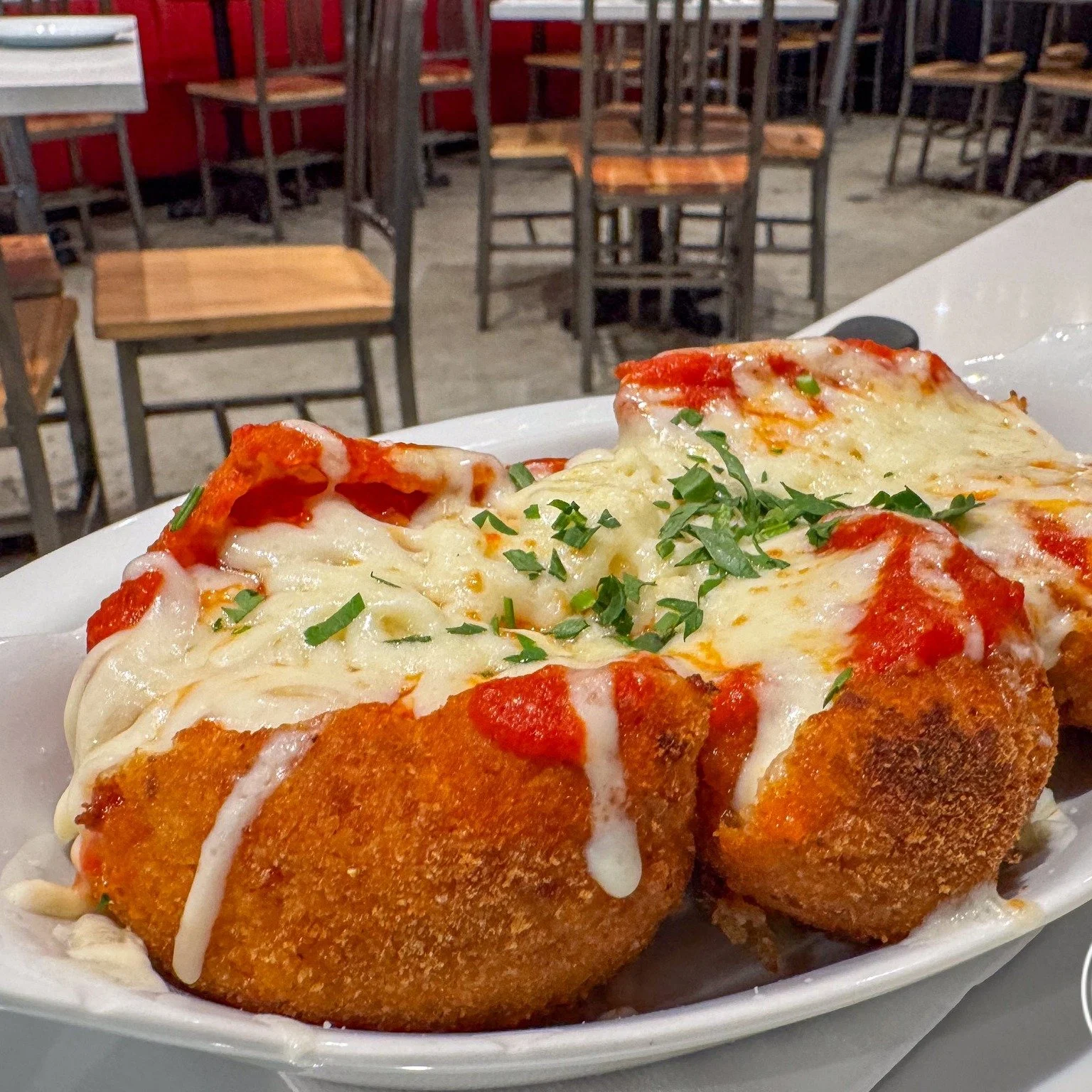 The arancini with parmesan at L&amp;B Spumoni Gardens in Dumbo are a must have! 😍 These golden rice balls are fried to perfection, offering a satisfying crunch that leads into a rich, creamy center. The sharp, nutty flavor of the parmesan perfectly 
