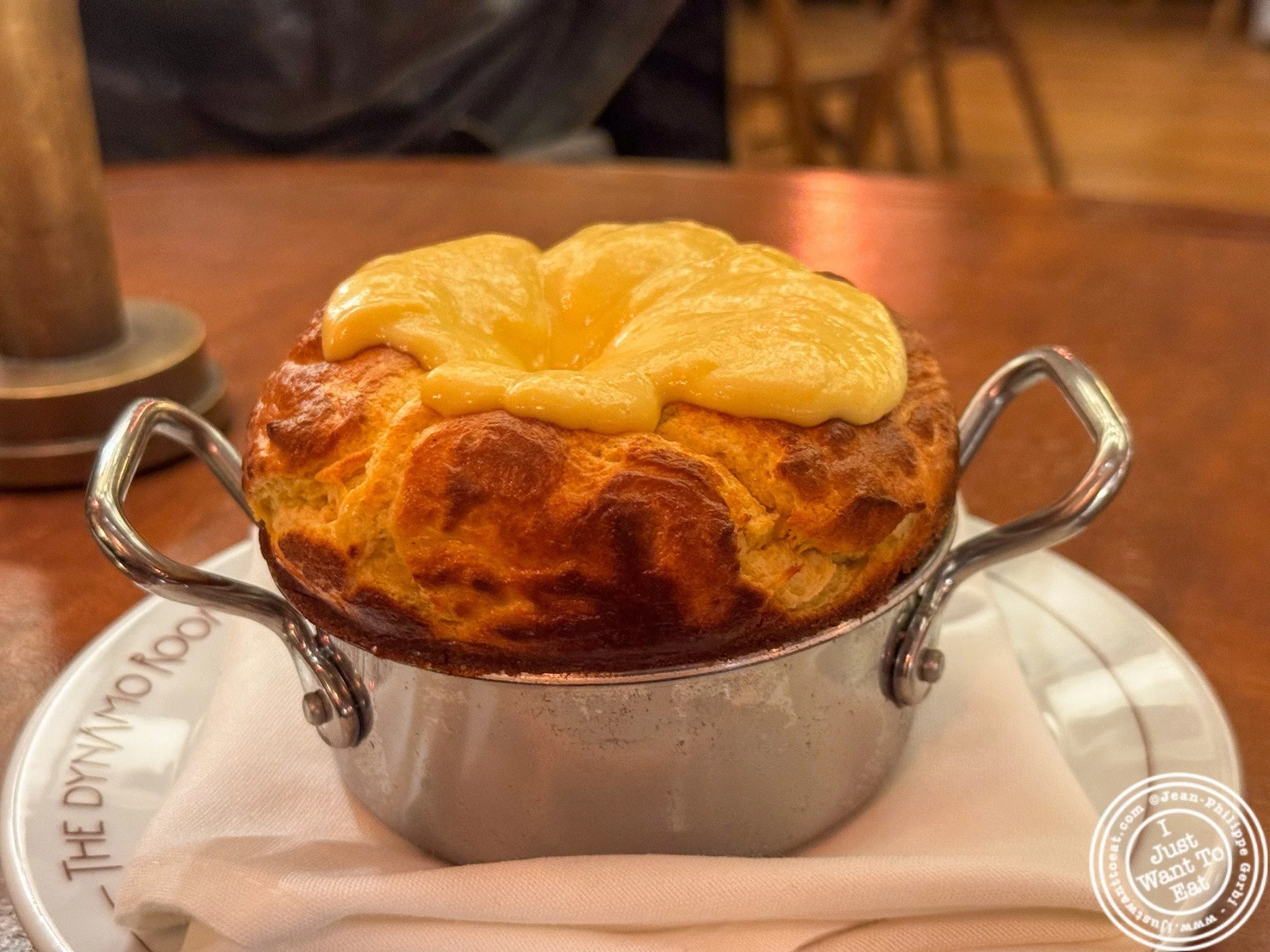 The Smoked Cheddar Souffl&eacute; at @thedynamoroom might just be one of the most unforgettable bites in NYC 🤍🔥 This beauty arrives puffed, golden, and impossibly airy and is smothered with cheese sauce&mdash; the kind of souffl&eacute; that winks 
