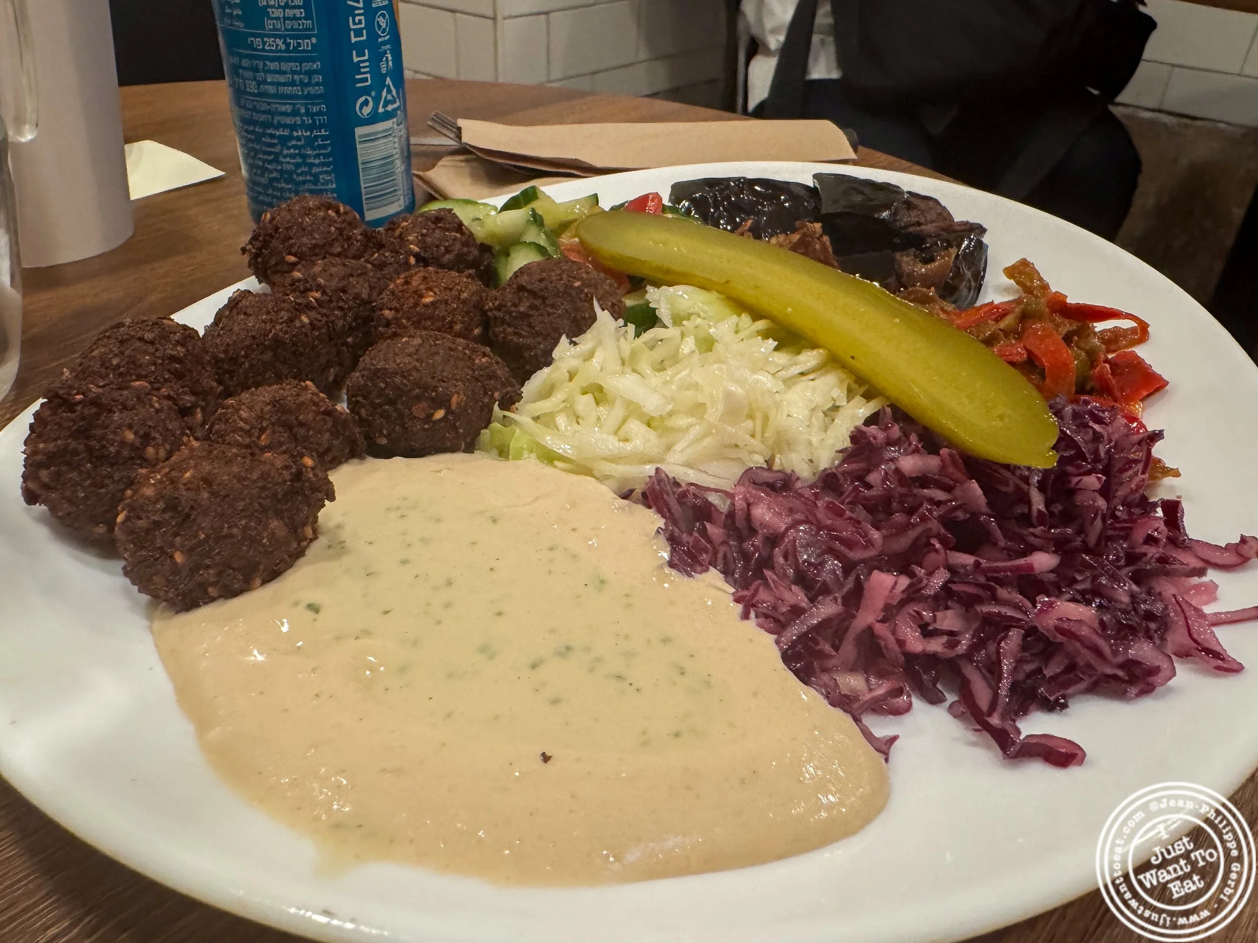 Falafel platter with grilled eggplant, fried onions and fried peppers, cabbage, cucumber tomato salad, hummus and tahini at King falafel palace / Le Roi du Falafel rue des rosiers Paris, France