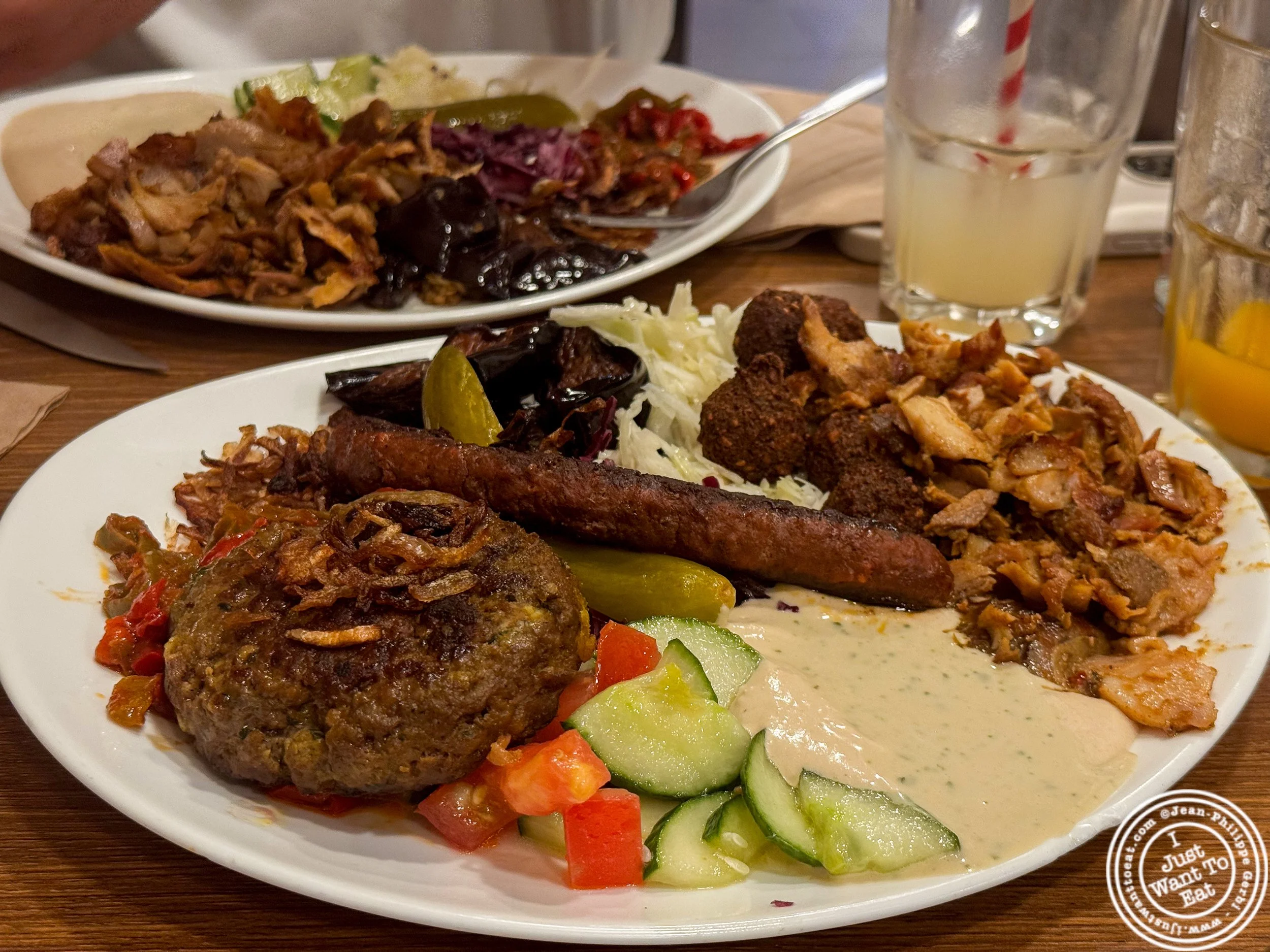 Royale platter with merguez, kofta, shawarma, grilled eggplant, fried onions and fried peppers, cabbage, cucumber tomato salad, hummus and tahini at King falafel palace / Le Roi du Falafel rue des rosiers Paris, France