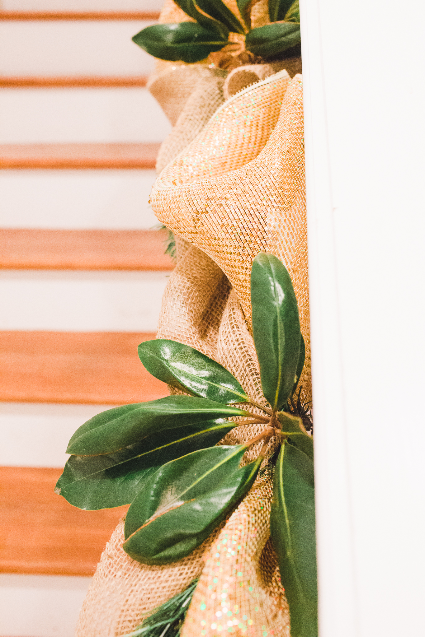 Burlap, ribbon, magnolia trimmings on the staircases; we have since added purple ornaments. 