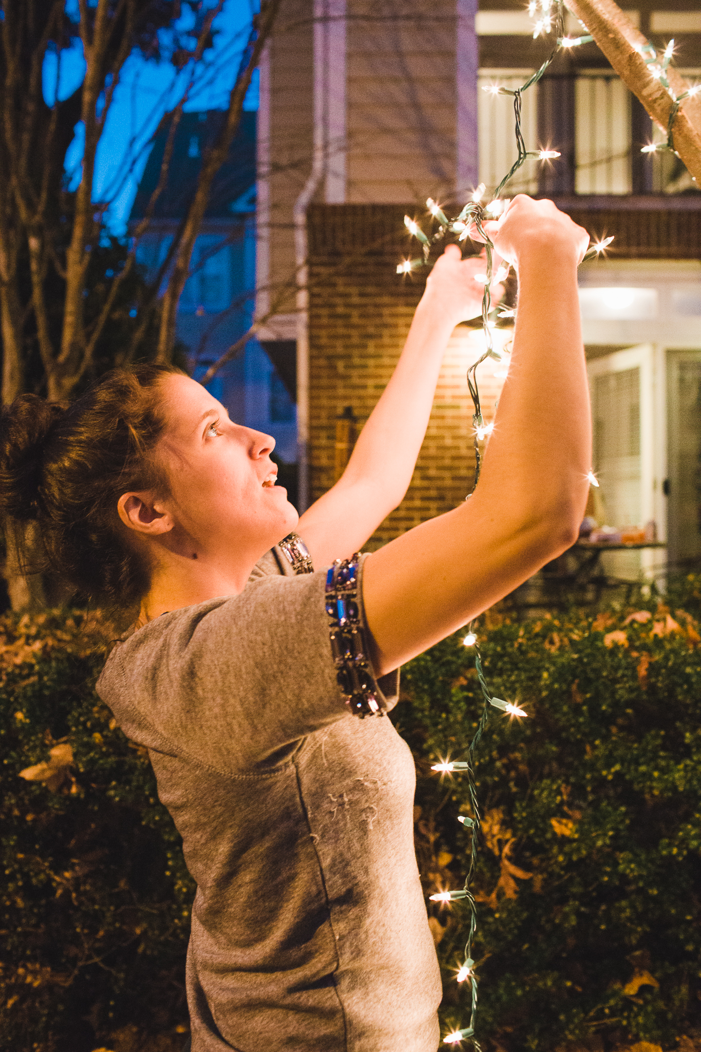 Elf #1, Haley, trimming the tree outdoors