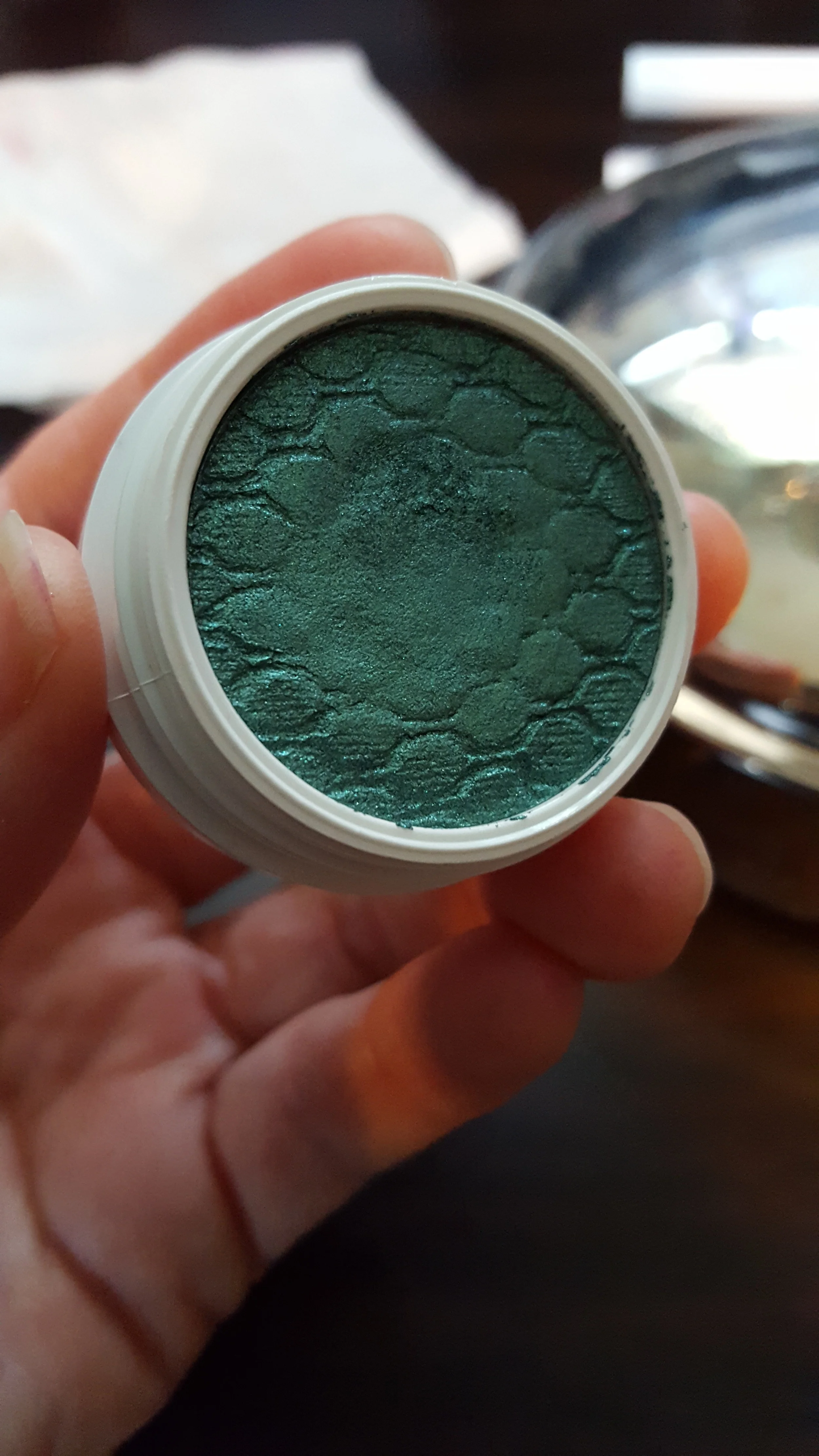This is an eye shadow in the color Flower Shop. All the powder products come in individual pots and are stamped with the same quilted pattern.