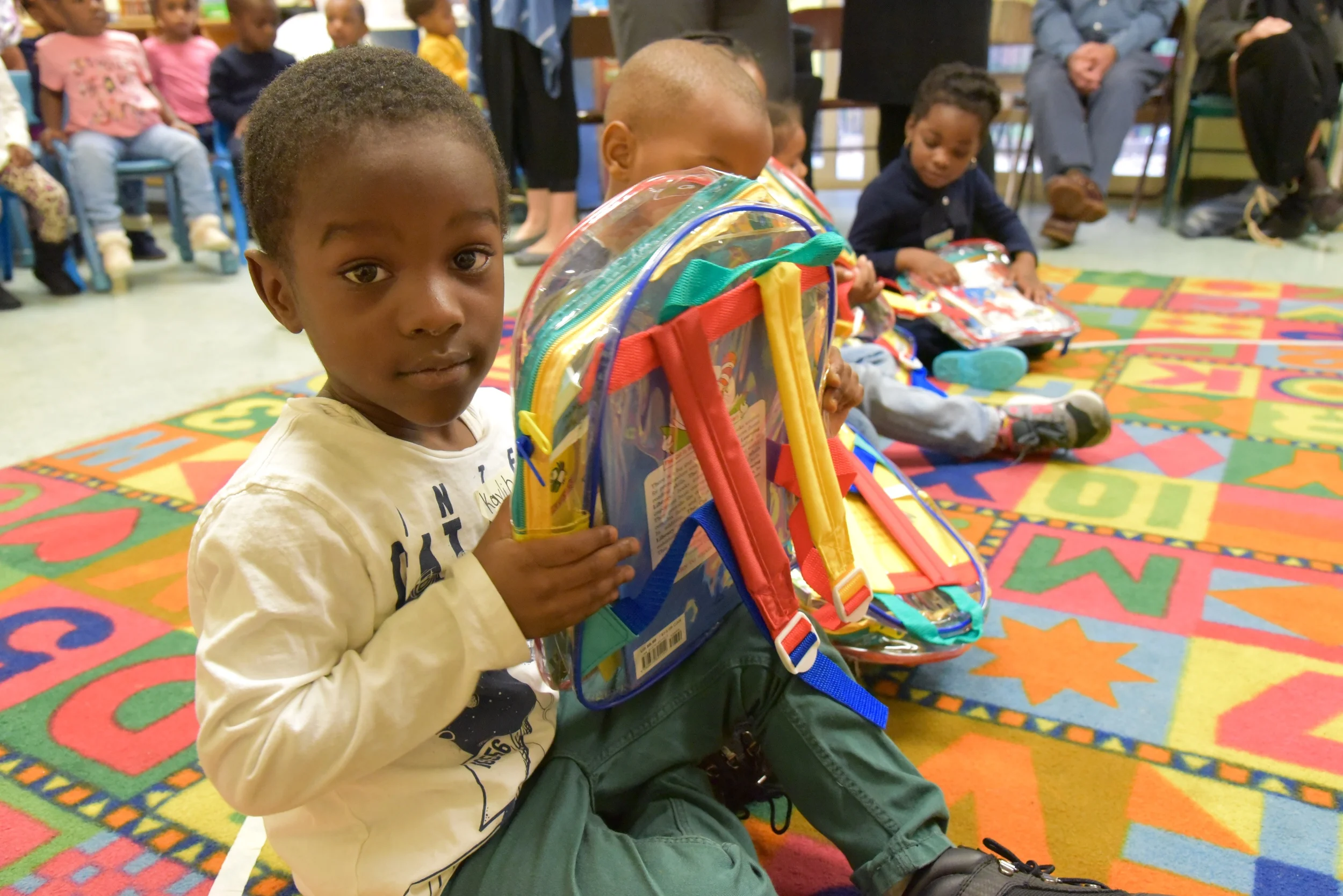 Pre-k students receive books from Inner City - Inner Child programs. Photo by Lana Wong