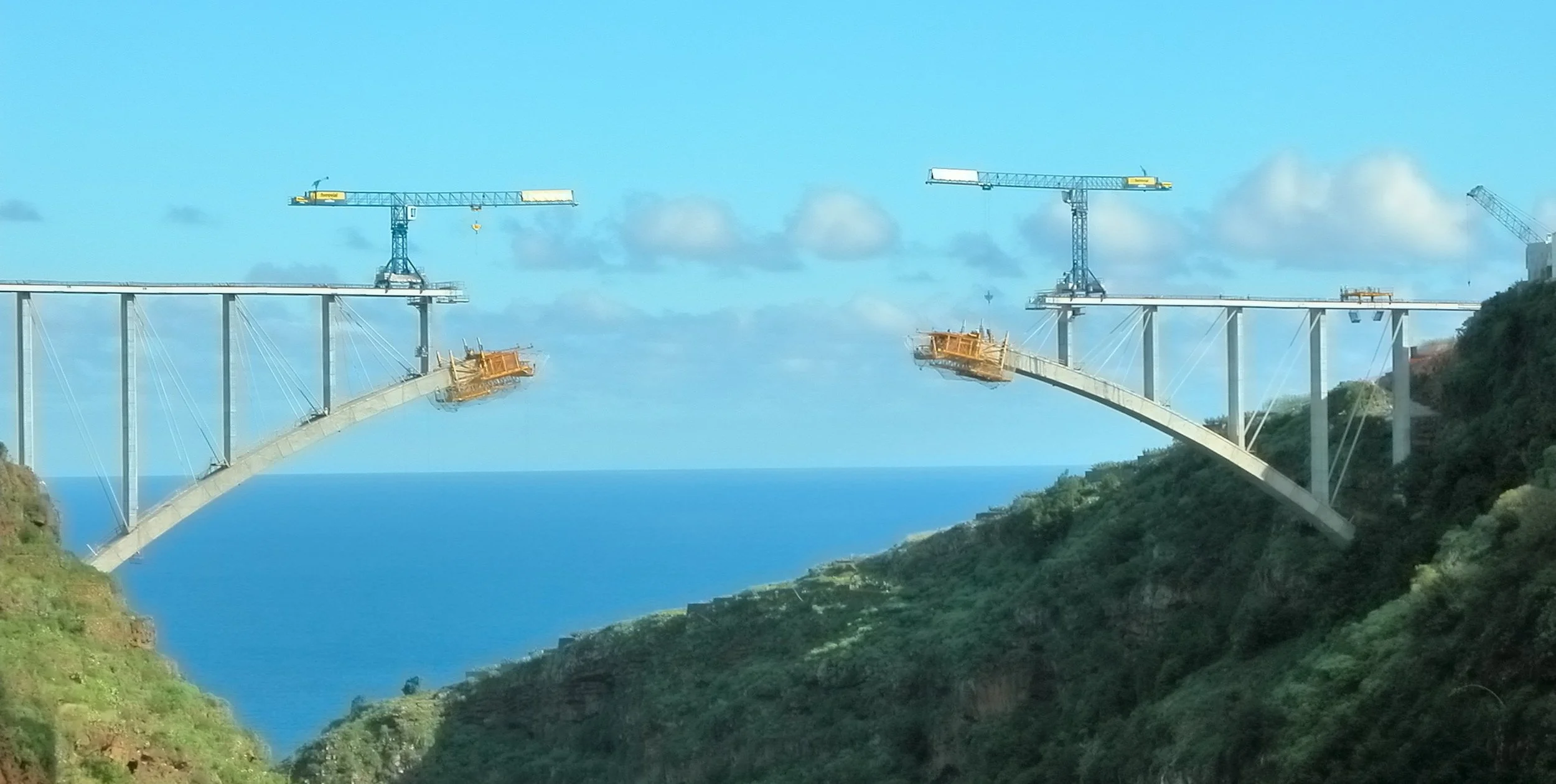 Bridge under construction spanning coastal cliffs - representing career transition from Big Tech to external opportunities