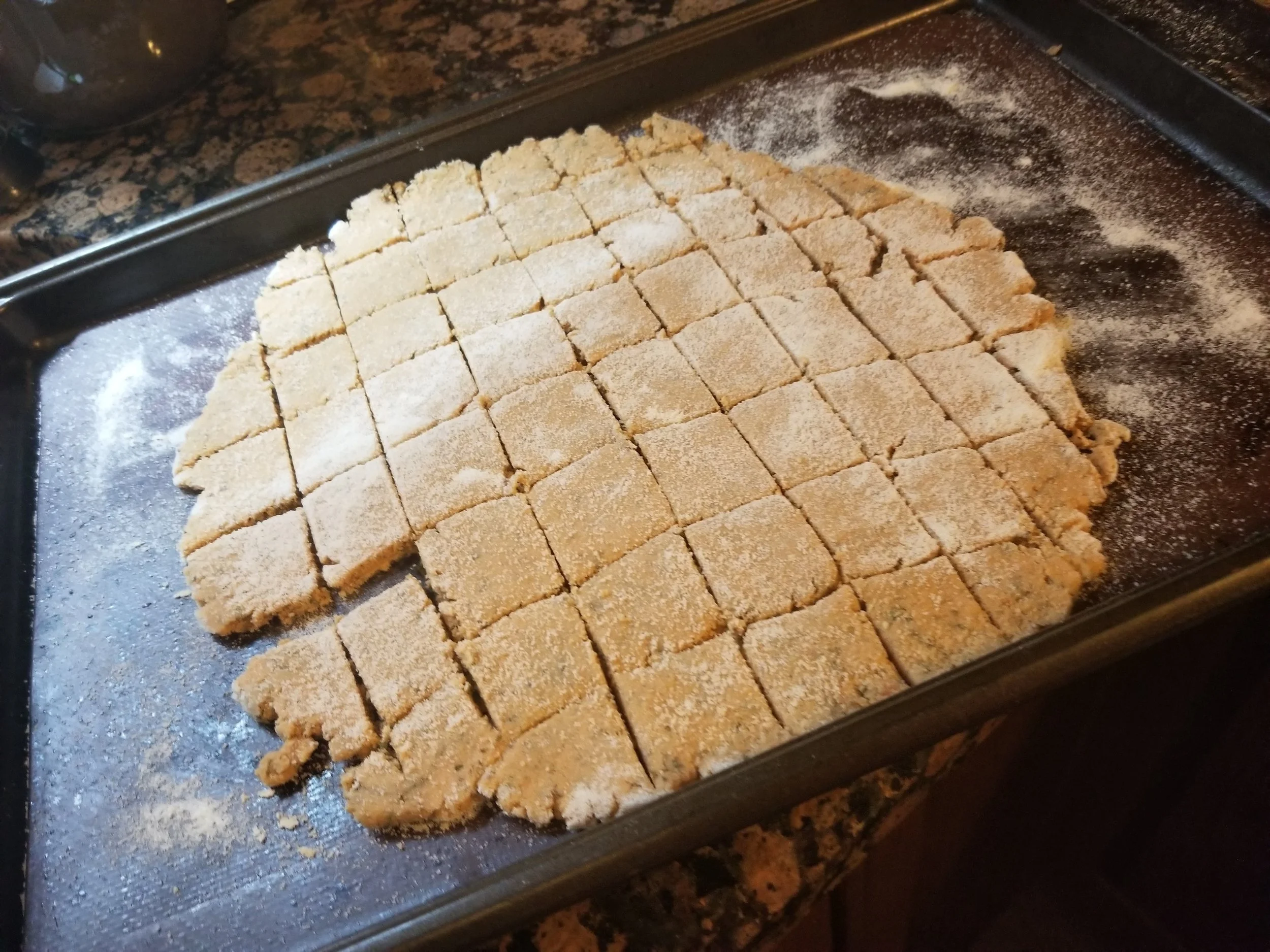 Roll out dough, using extra rice flour where sticky, to about 1/4” thick, then score with a knife.