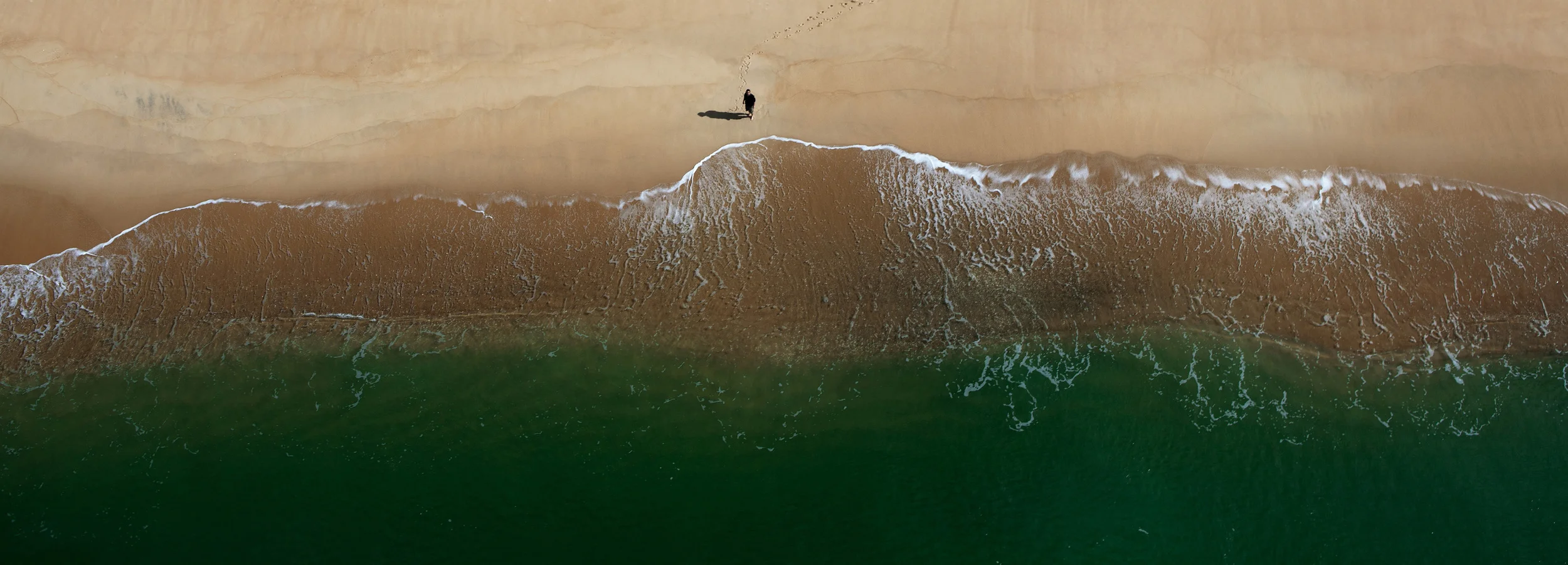  Meanwhile at the edge of the world, a man stood,&nbsp;with his feet sinking into the sand while the ocean gnawed at their flesh,&nbsp;threatening to take them forever. Then, he looked up. 
