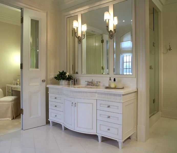 This client wanted his new home to celebrate his North American achievements and European heritage. After conceiving all the interior volumes and spaces, we used a variety of motifs, textures and patterns so that each room has its own mood, yet a common richness unites the home. In the centrepiece of her bath, the vanity’s graceful curves and fine detailing add classical yet feminine character.