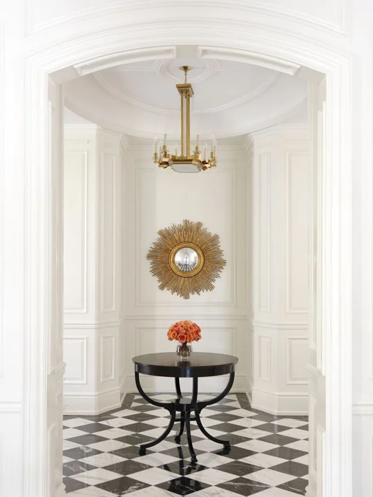 Although they love traditional design, this Florida-based couple wanted their Canadian summer home to be a fresh, light and lively place for the whole family, including very young children and a dog. The simplicity and freshness of the interiors reflects their lifestyle, while respecting the neoclassical character of the home, as exemplified in this classically detailed foyer enlivened with only three special furnishings.