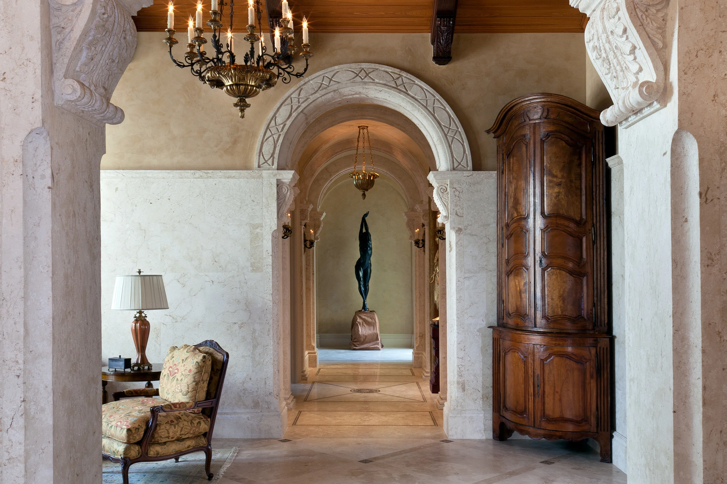 Although most of the furnishings were provided by a local decorator, Lisa Kahn, with whom we worked closely, we sourced certain special pieces, such as a pair of extraordinary Lyonnais walnut cured door encoignures c.1780 found in France. These 10 foot tall units were positioned in the corners of the entry from the living room to the covered loggia. Their shape softens the corners of the room and their detailing works well with the intricately detailed stonework we designed.