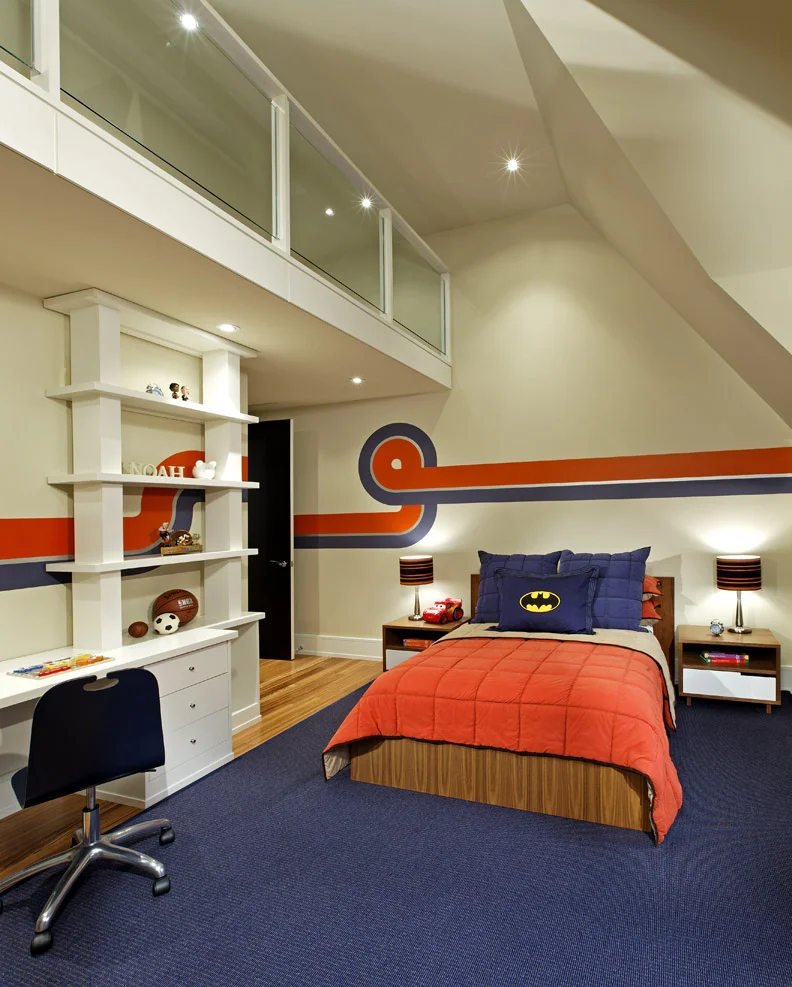 Below this room’s loft play area there’s plenty of storage for clothes and toys, all surrounded by a racing super graphics theme in the 4 year-old boy’s favourite sports teams’ colours.