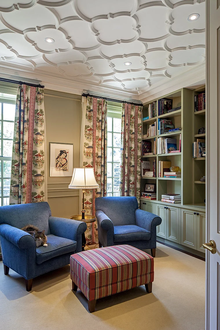 Adding a subtle rhythm to the space, the ceiling is just part of the masterfully planned detailing for this cozy room. The pale plush wool carpet and warm apple green paint finished cabinetry create a subtle background for the fine wood block print by Yoshitori Mori, dean f Japan’s modern print makers, which is flanked by drapery in a playful pagoda print. The existing chairs were reshaped an upholstered for this space.