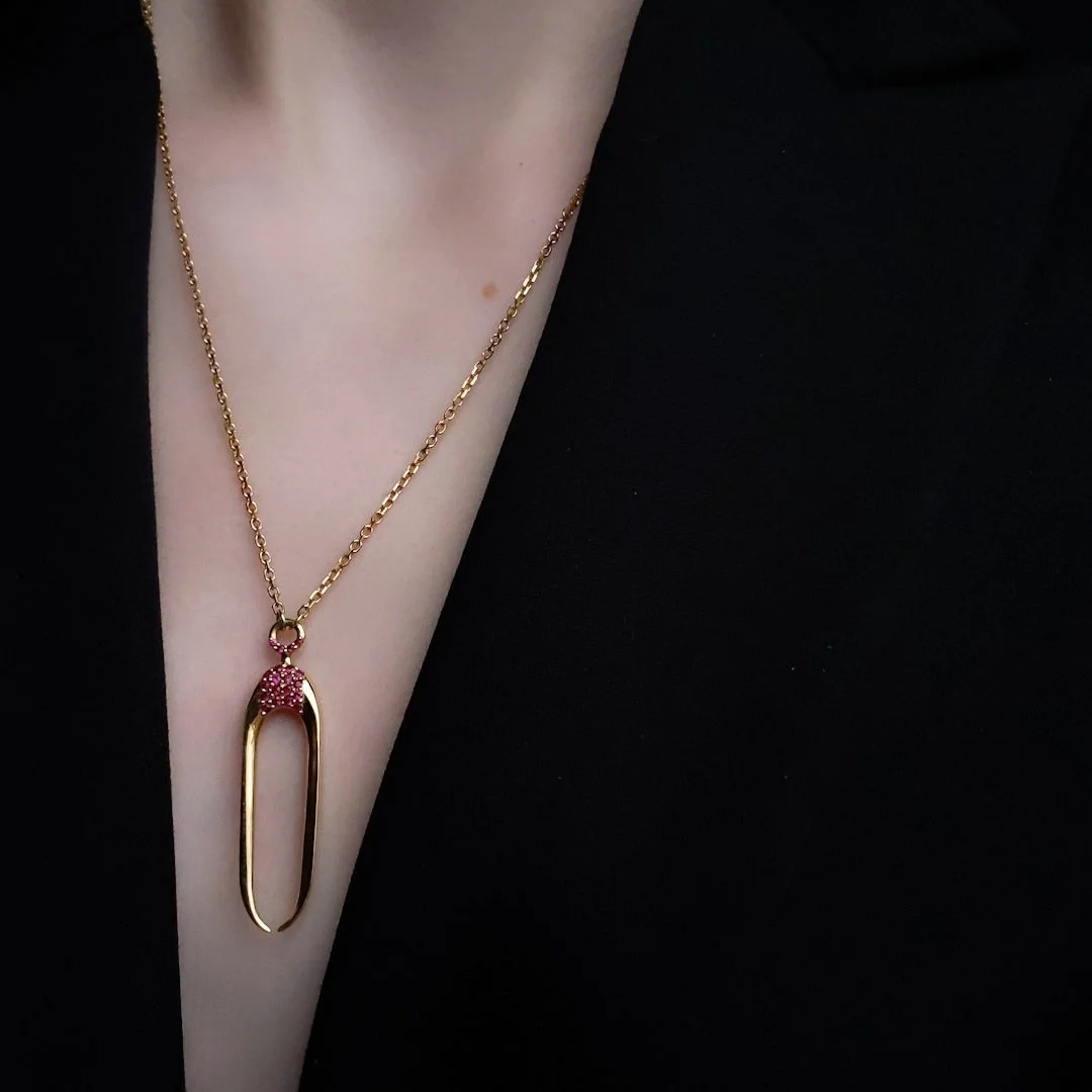 An edgy and fashion-forward gold necklace with rubies ready for day into night wear.