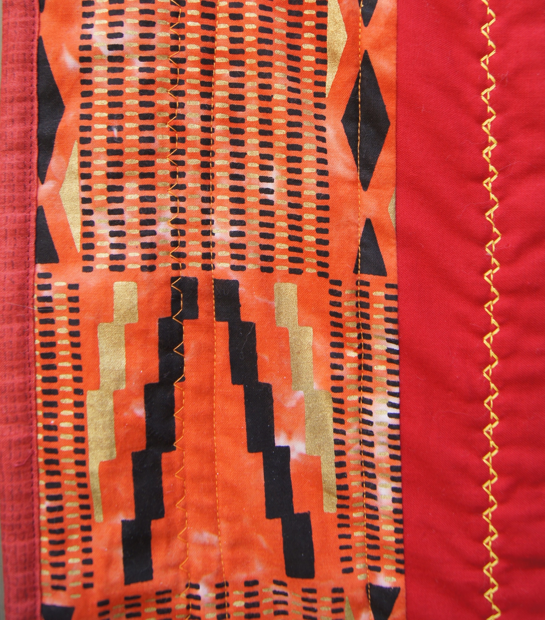 Straight stitching with the walking foot and 2 decorative stitches in the outer quilt border.