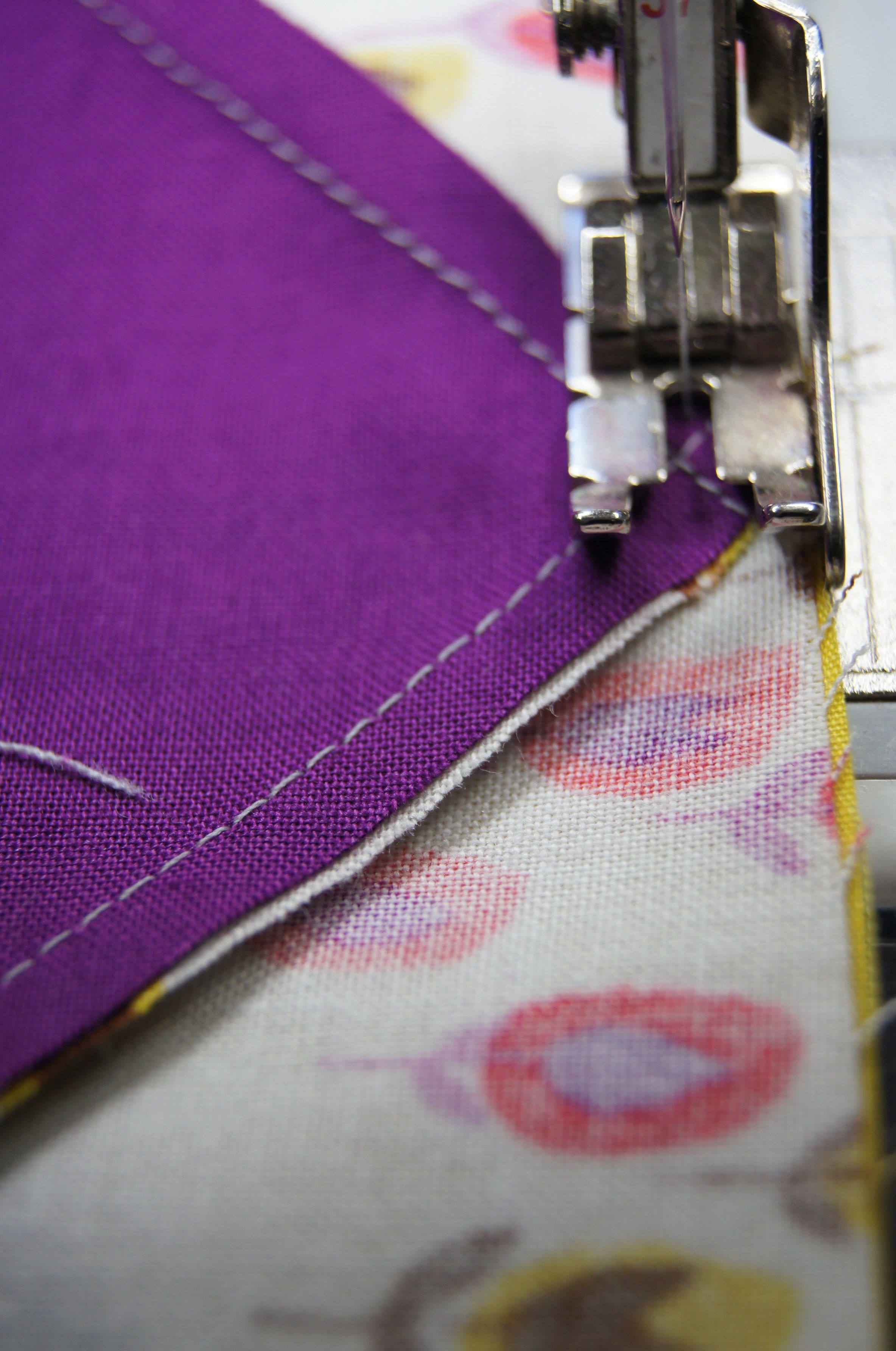 Sewing across the "x" formed by the stitching at the center of the block. 