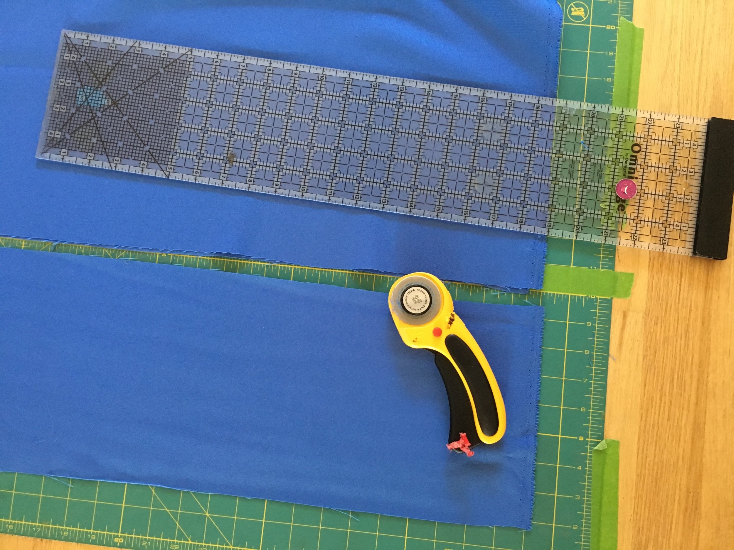 Note how the cut edge of the fabric matches the LOWER edge of the painters tape