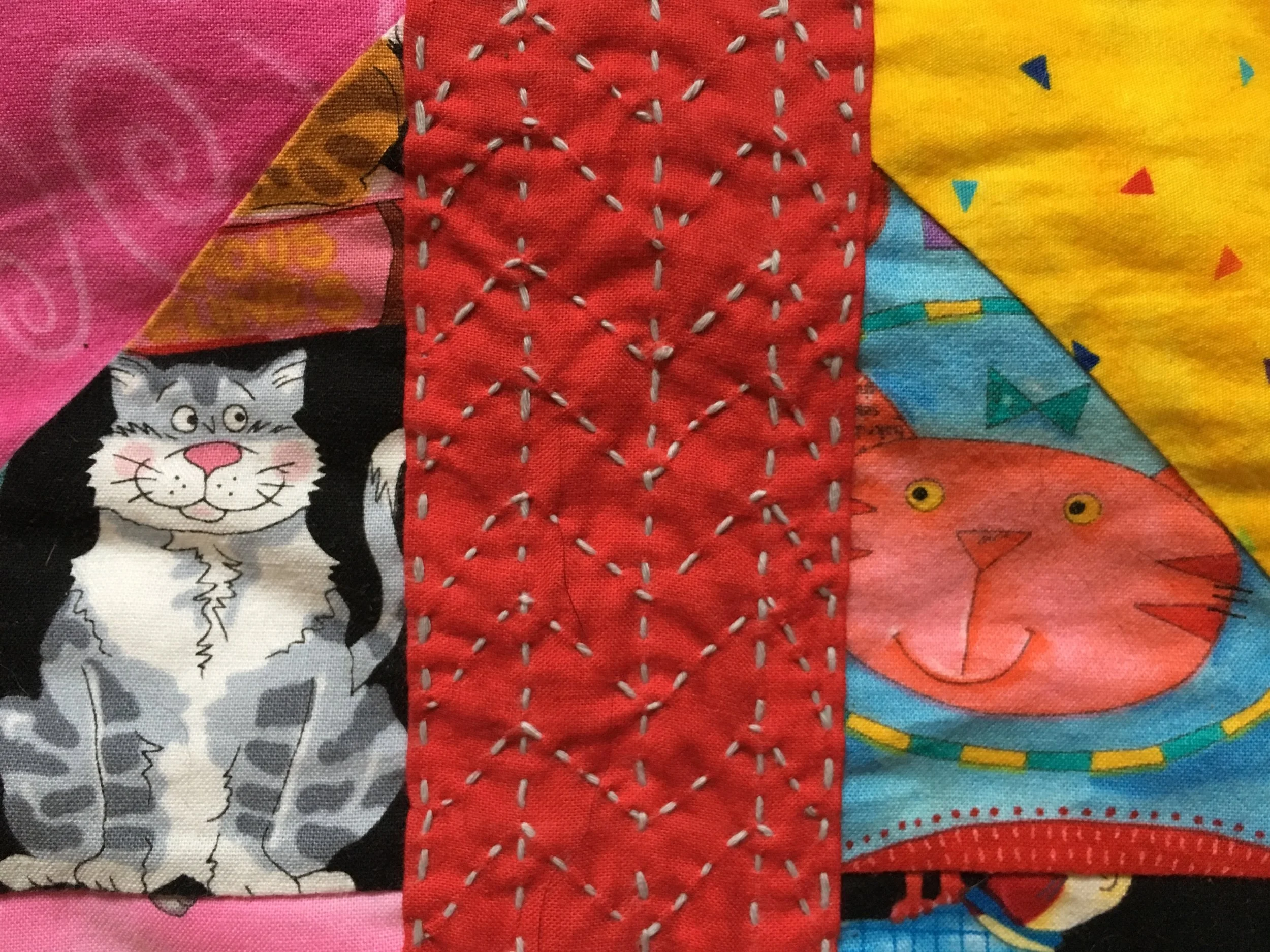 Close up of Visible Mending on a quilt. The cats seems to approve of the new addition!