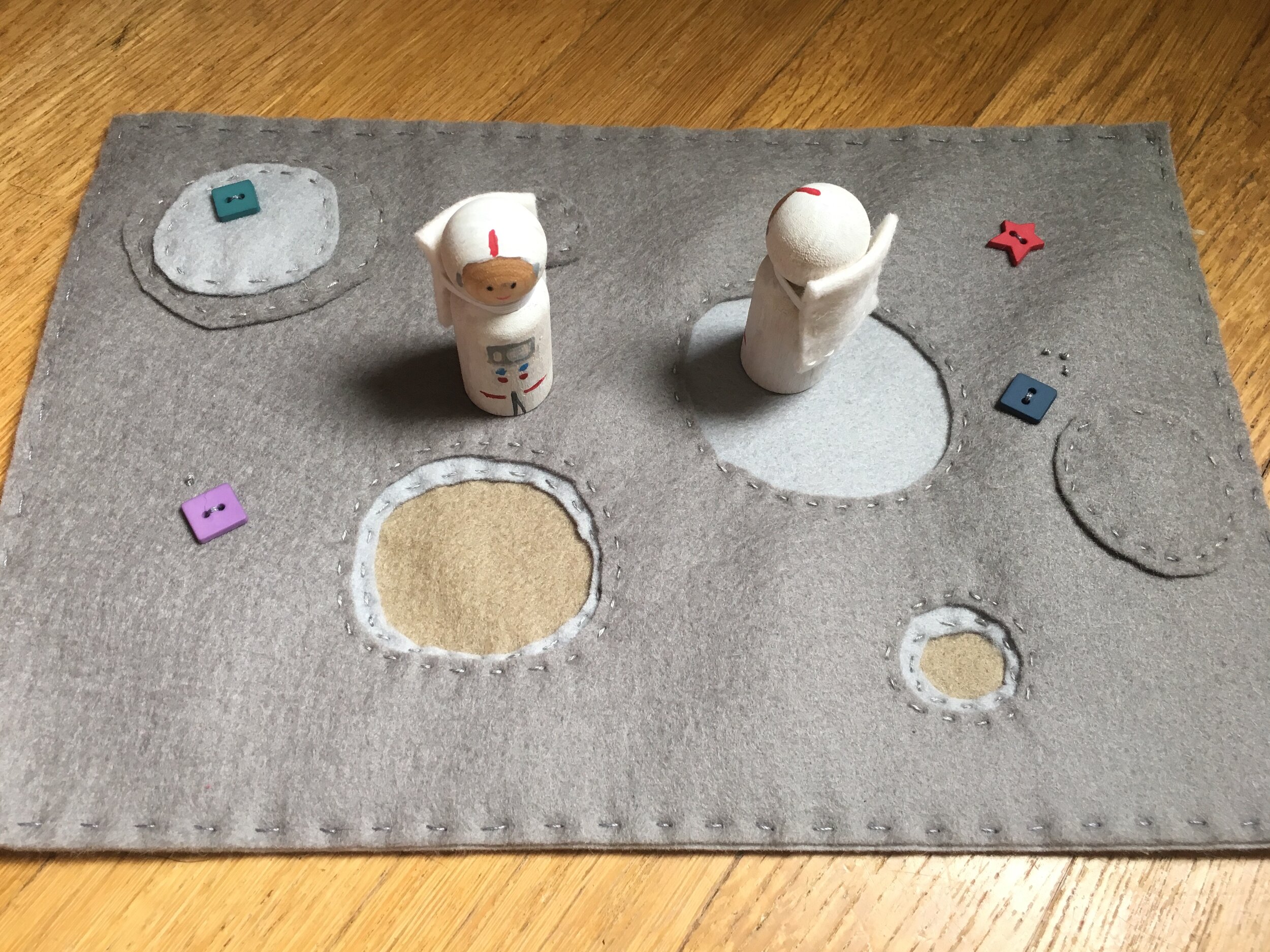 Felt lunar playscape with standard peg doll astronauts