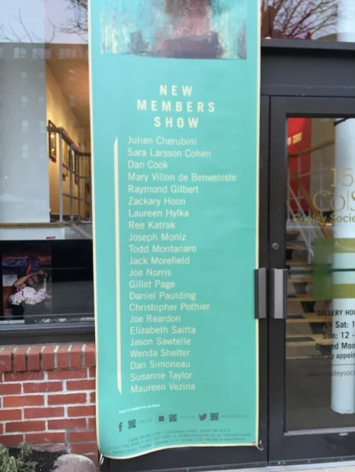 The banner outside the gallery announcing the show and the artists