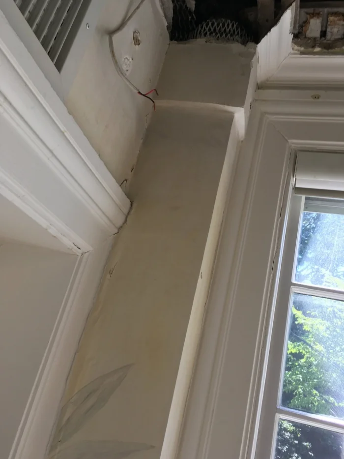 The corner before plastering -- showing damage and original mural