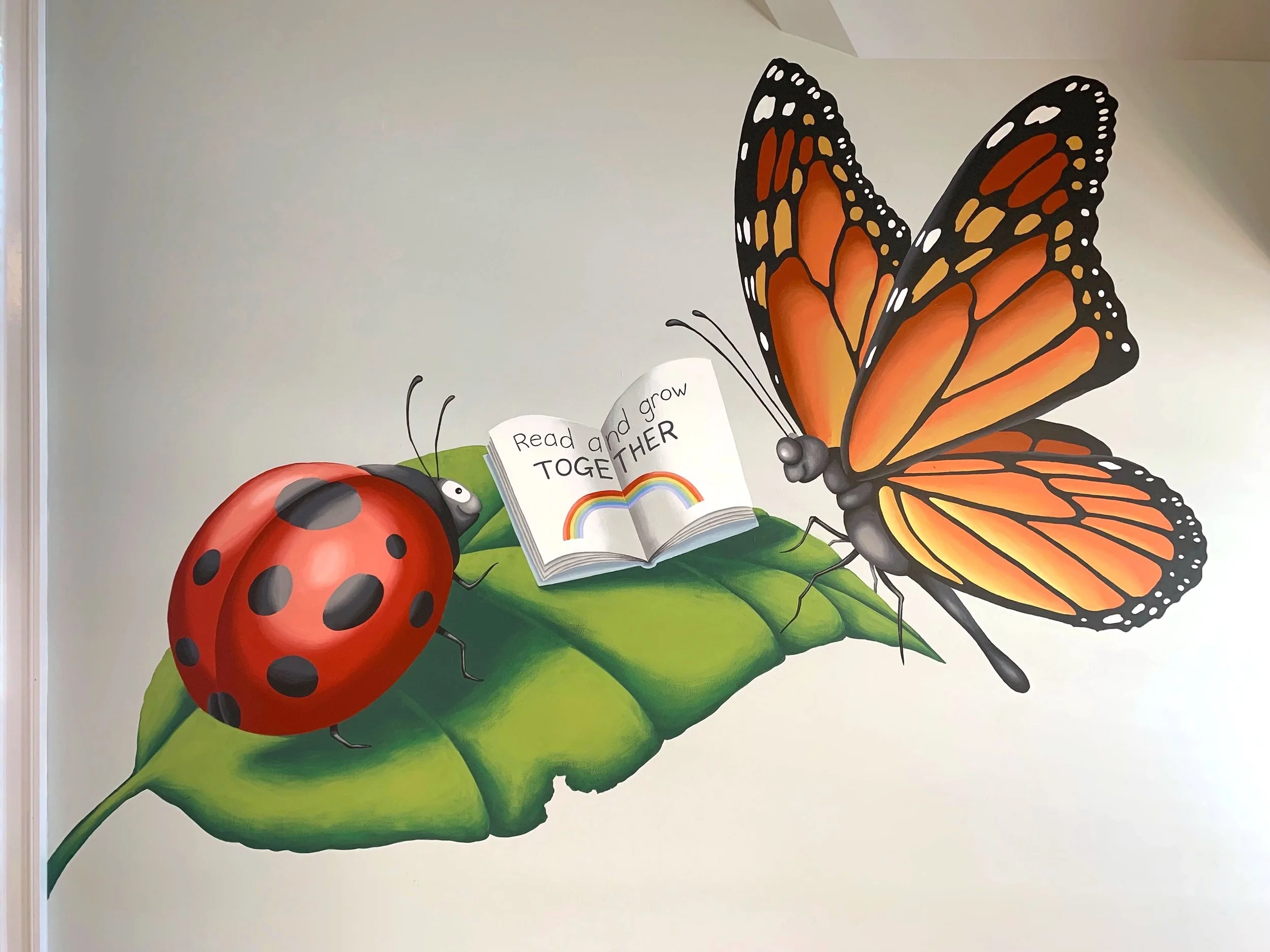 Two-panel "story" mural at the Westwood, MA Library Islington branch