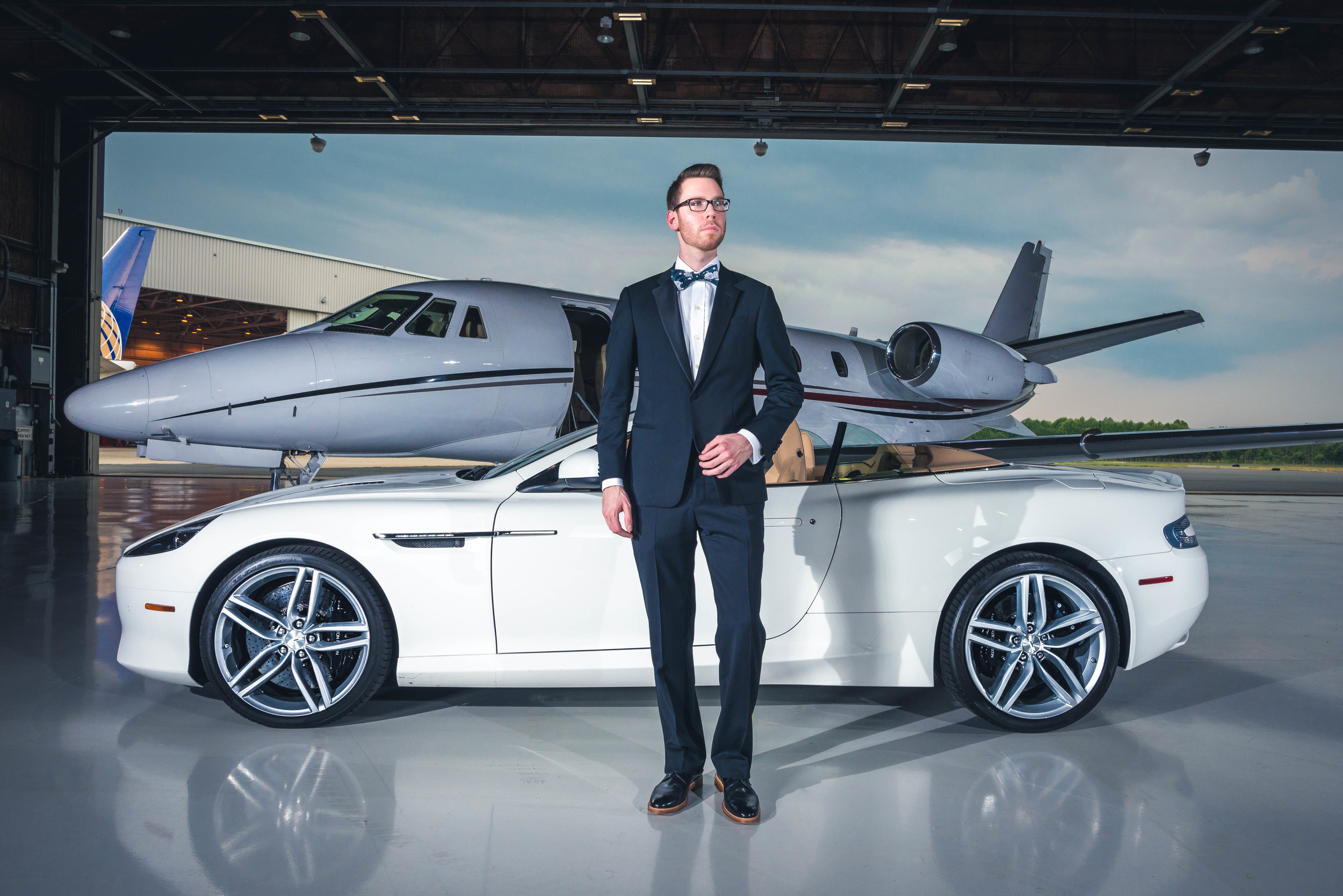 Tuxedo: Armani Collezioni(courtesy Saks Fifth Ave.), Shirt: Ledbury, Tie: The Tie Bar, Shoes: Crosby Square, Glasses: Burberry, Car: 2014 Aston Martin DB9 Volante(courtesy Foreign Cars Italia), Photo: Alec Hutchins Photography, Model: Noah Williams 