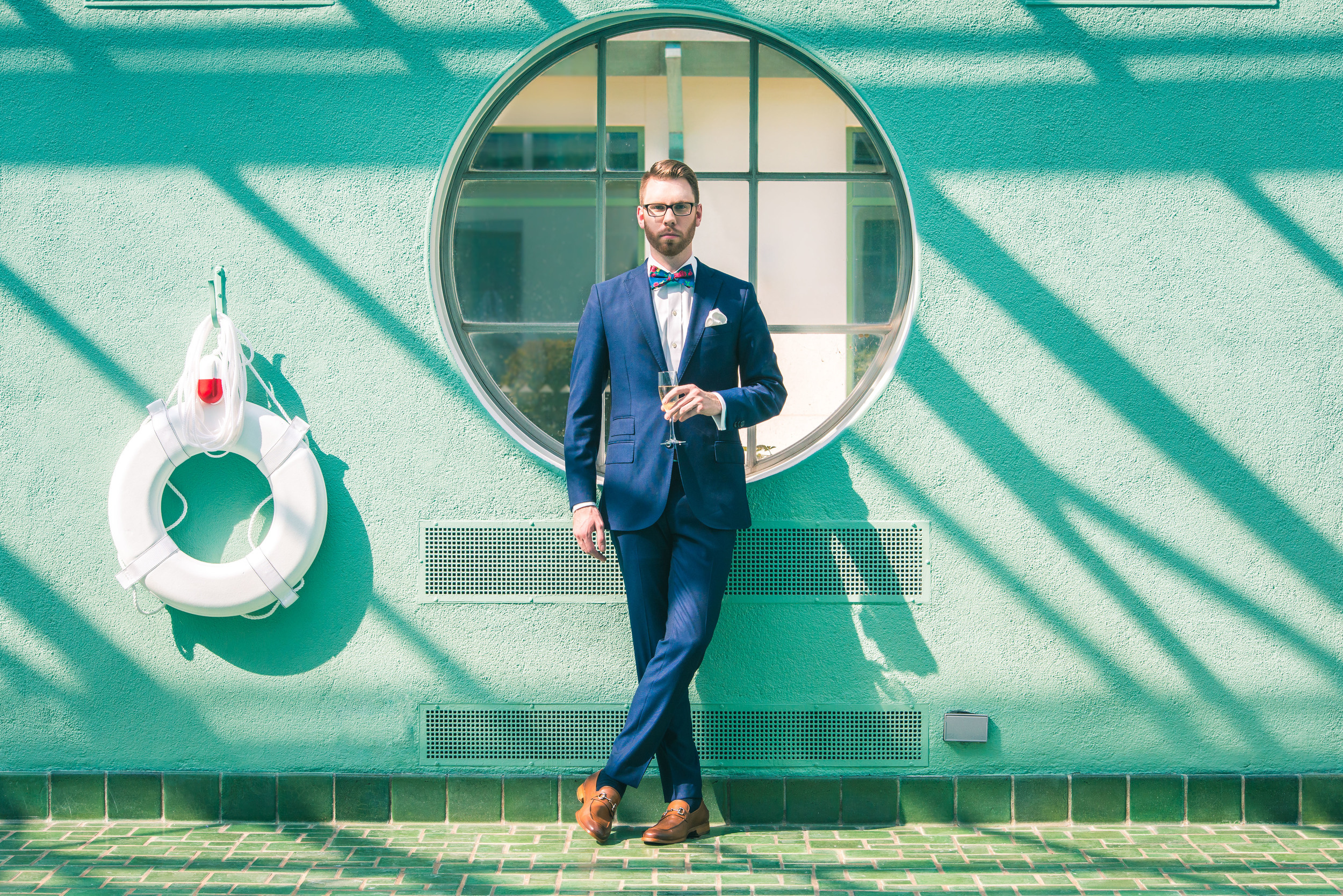 Suit: J. Lindeburg, Shoes: Johnston & Murphy, Shirt: Ledbury, Tie: The Tie Bar, Glasses: Burberry, Photo: Alec Hutchins Photography, Model: Noah Williams, Location: Reynolda House Museum of American Art historic indoor pool.