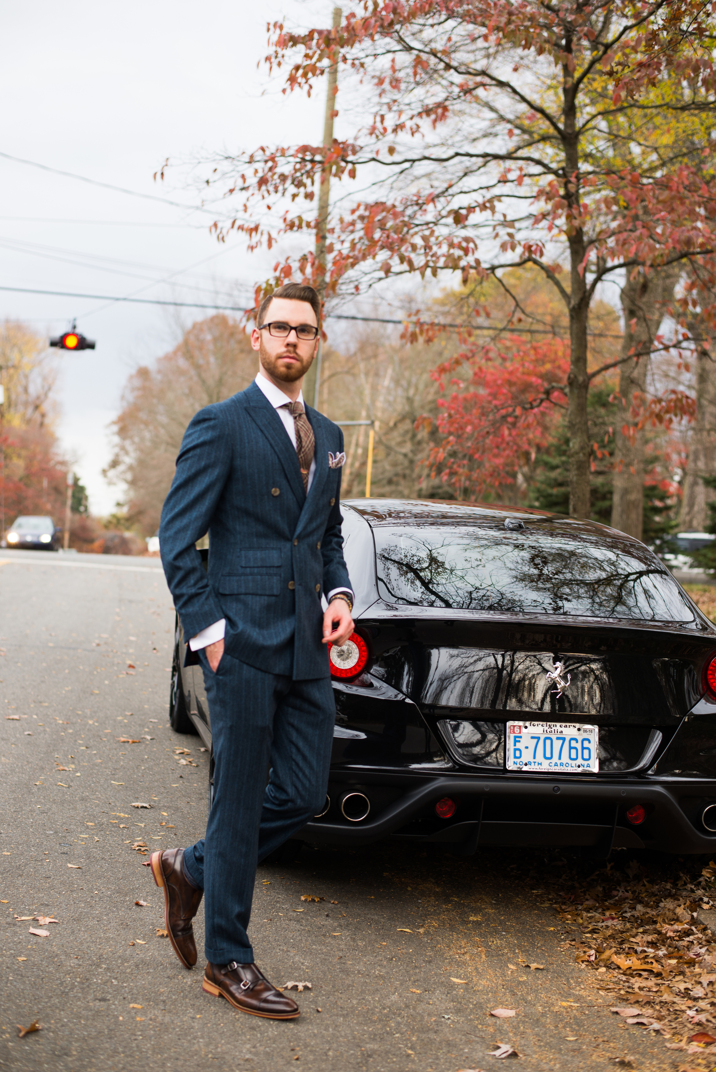 Suit: Indochino, Shoes: Johnston & Murphy, Glasses: Burberry, Watch: Snyper, Shirt: Ledbury, Tie/Pocket Square: Sprezza Box, Car: Ferrari FF, Photo by Alec Hutchins Photography, Hair styled by: Carlos Carvana; Owner The Oval Office. 