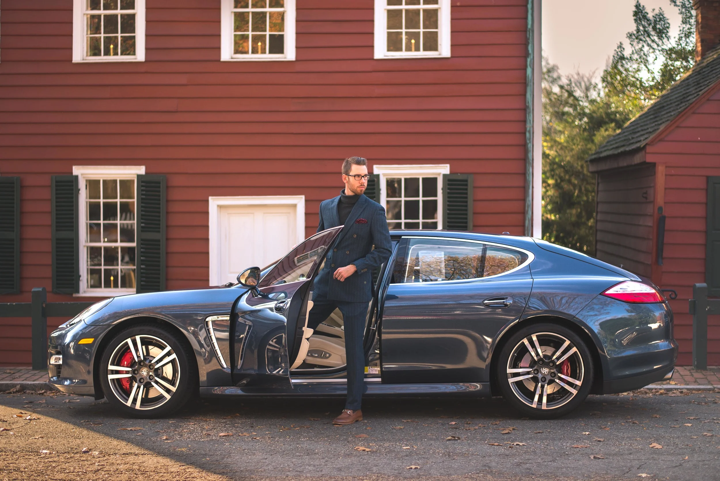 Suit: Indochino, Shoes: Johnston & Murphy, Glasses: Burberry, Sweater: Ralph Lauren, Pocket Square: Bows-n-ties.com, Car: Porsche Panamera, Photo by Alec Hutchins Photography, Hair styled by: Carlos Carvana; Owner The Oval Office. 