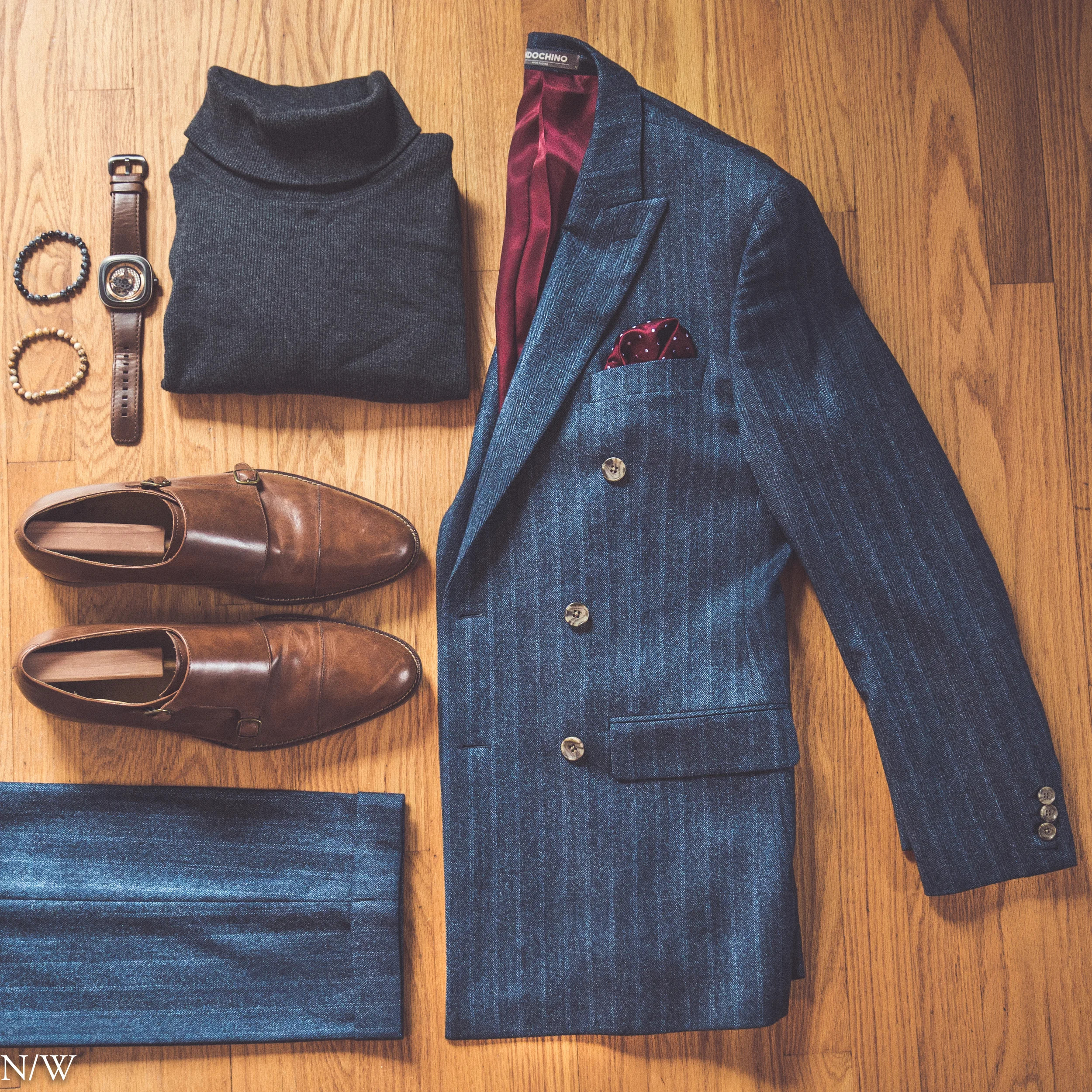 Suit: Indochino, Shoes: Cole Haan, Sweater: Ralph Lauren, Watch: Seven Friday, Bracelets: Our Saints, Pocket Square: Bows-n-ties.com. 