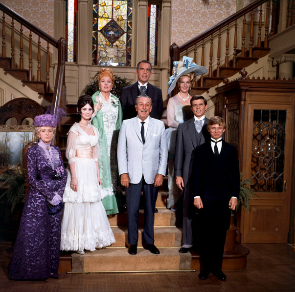 The cast of The Happiest Millionaire surround Walt Disney.
