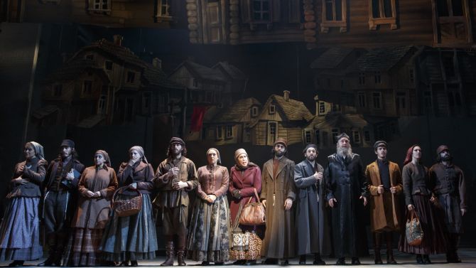 "The Rumor" in Fiddler on the Roof , led by Alix Korey (center).