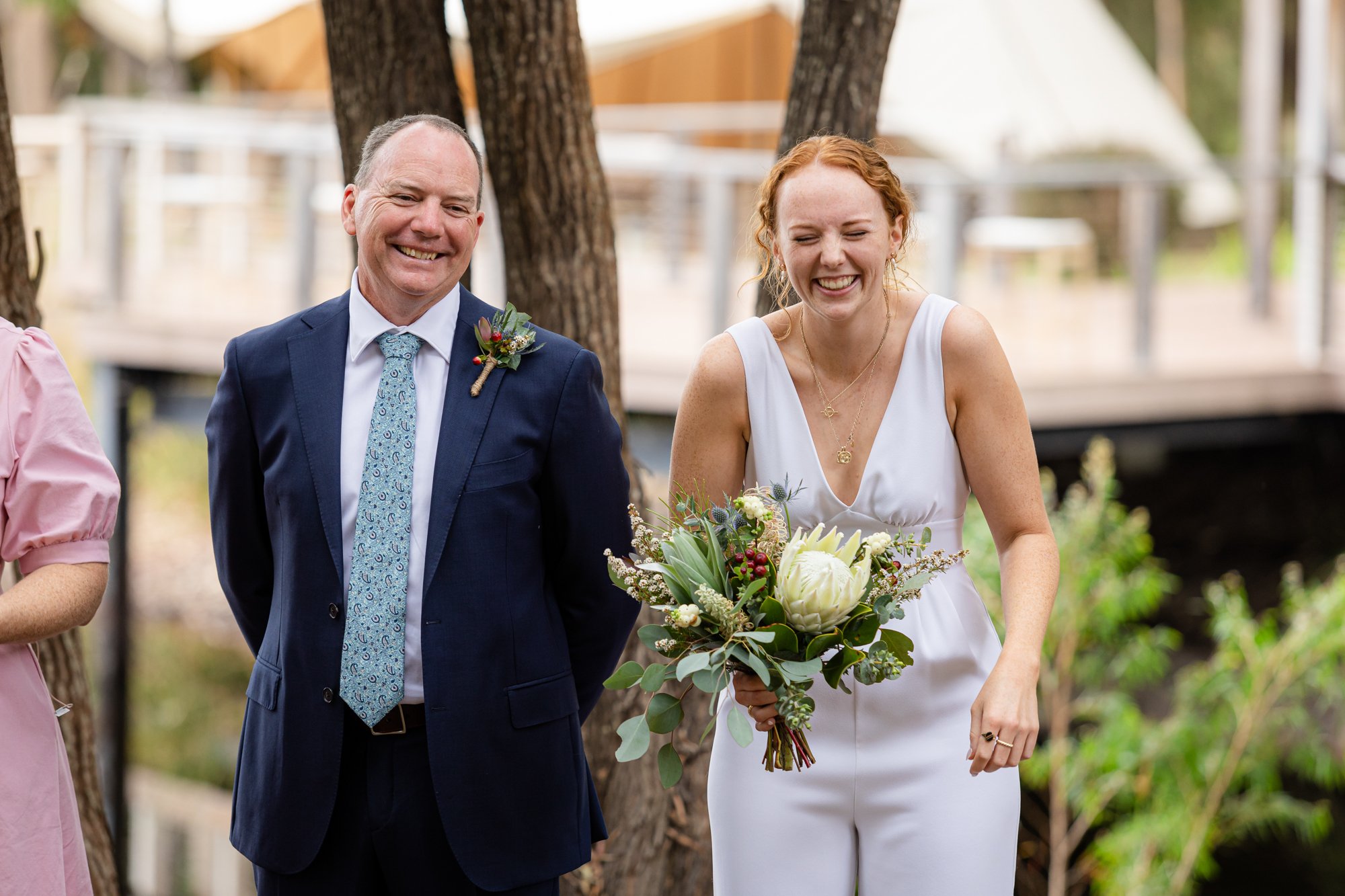 a  guy and a lady holding a white bouquet