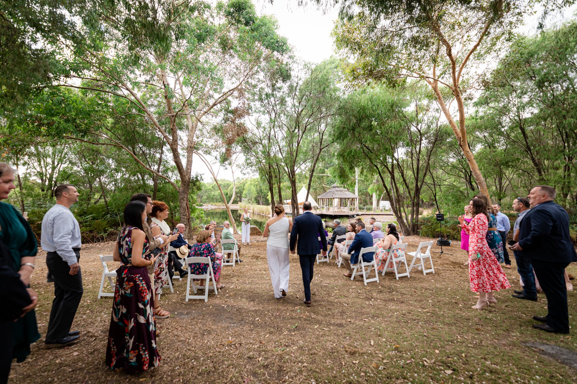 Bride and Groom walking down the aisle while the guests are watching