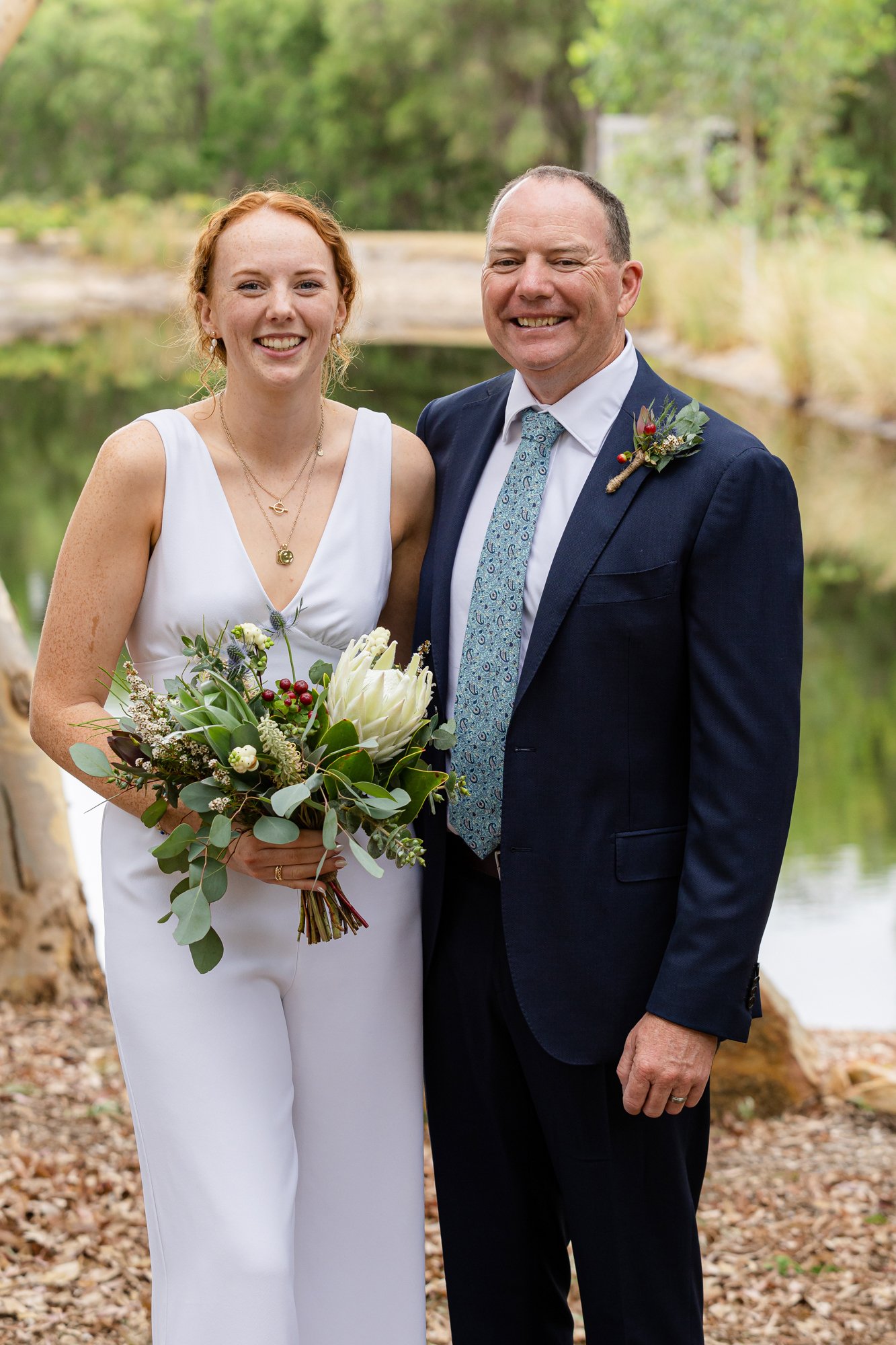 lady in wedding dress holding white bouquet with handsome groom