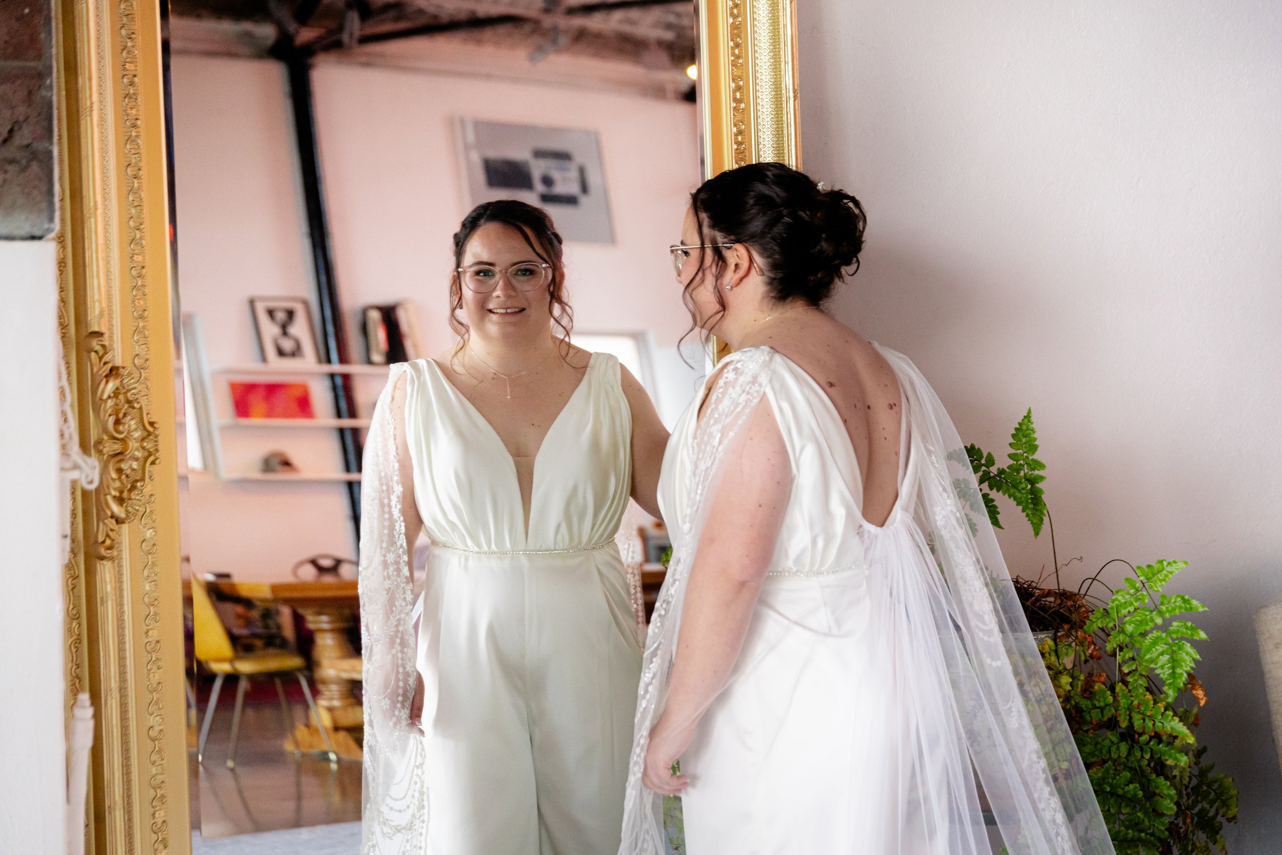 beautiful bride facing the mirror