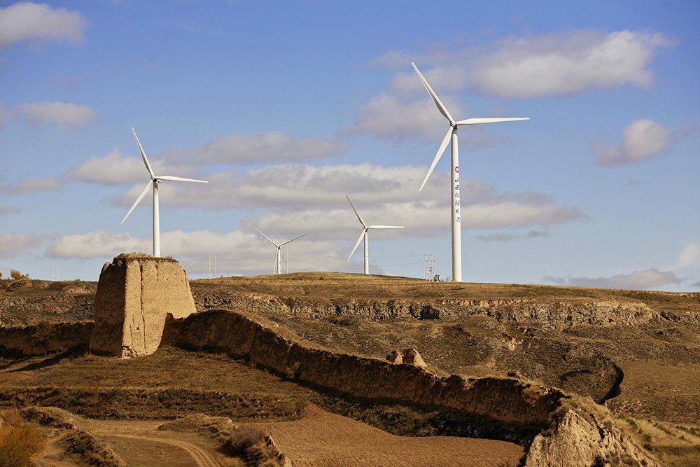  Wind mills amidst a neglected portion of the Great Wall of China, seen on the outskirts of Inner Mongolia. 