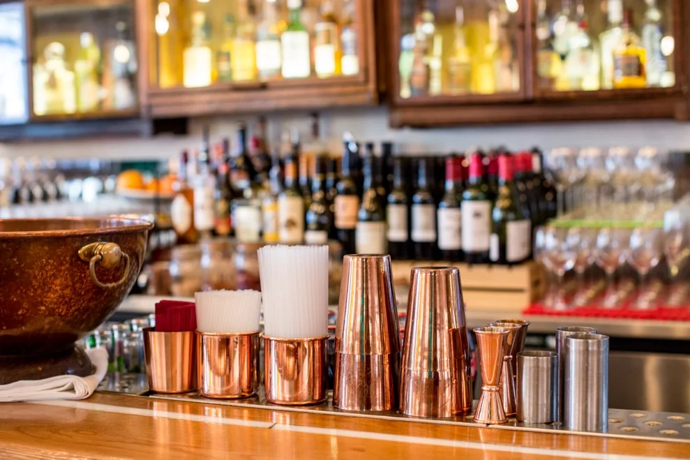 Tanner & co interior, drinks and copper measuring jugs on the bar