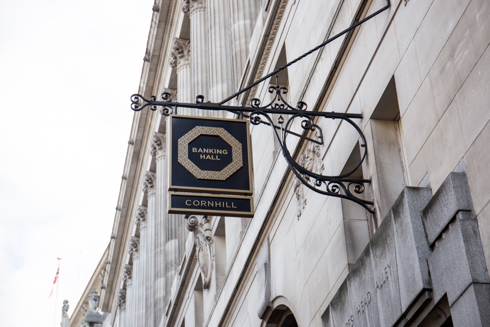 Banking hall exterior, the venue's sign hanging from a wrought iron support