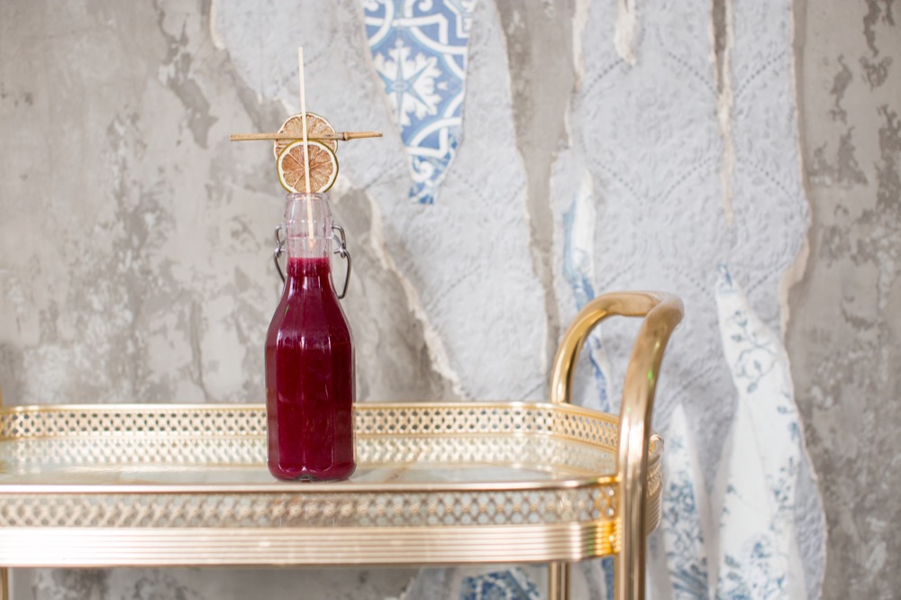 Six Storeys interior, a pop-top bottle containing a raspberry coloured cocktail