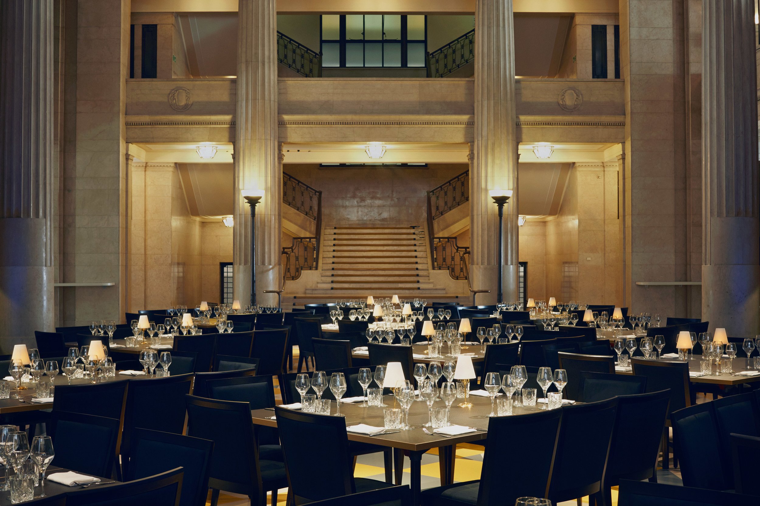 Banking Hall interior, rows of tables, each seating up to eight people, set for dinner in the banqueting hall