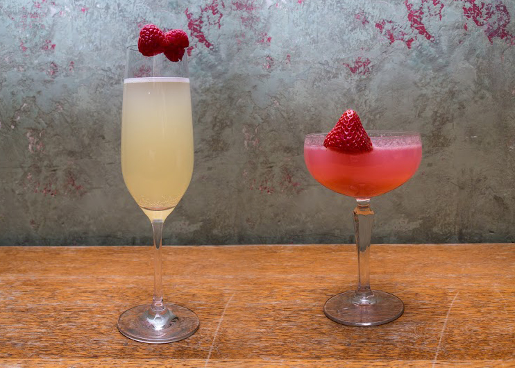 a tall thin pale yellow cocktail and a shallow pink cocktail